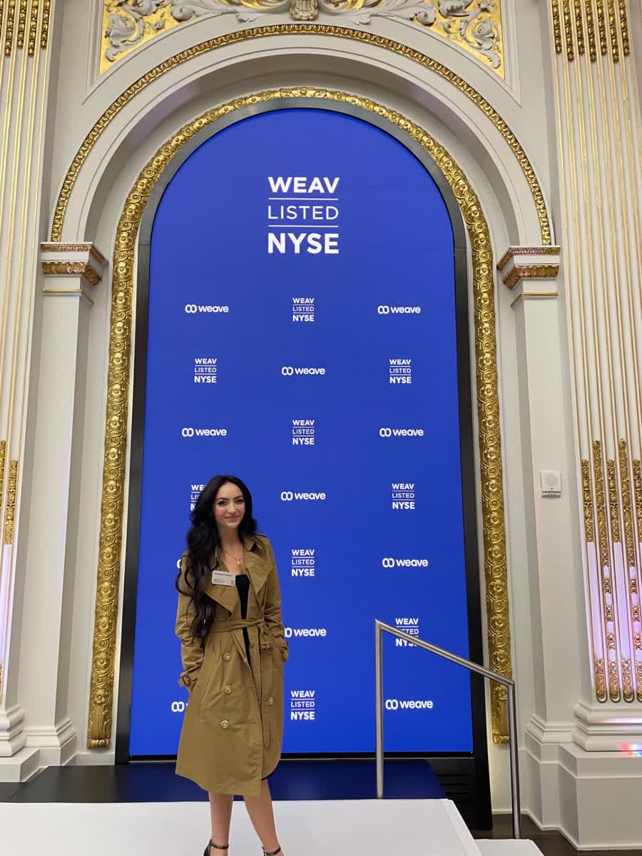 Cassandra Freeman at a listing-event backdrop inside the New York Stock Exchange